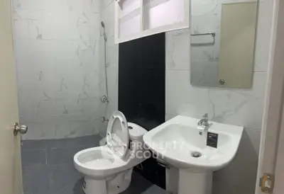 Modern bathroom with sleek fixtures and marble tile design