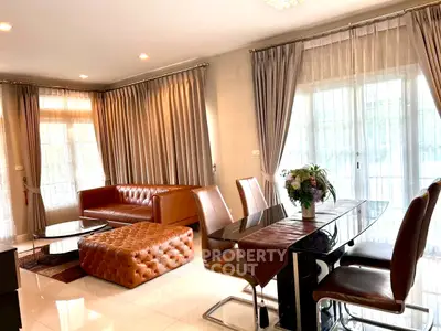 Luxurious living room with elegant leather furniture and large windows for natural light.