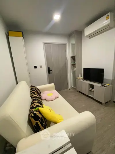 Cozy living room with modern decor and air conditioning in a stylish apartment.