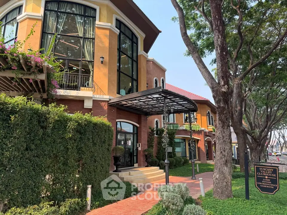 Charming Tuscany-style townhouse with lush greenery and elegant architecture, perfect for luxurious living.