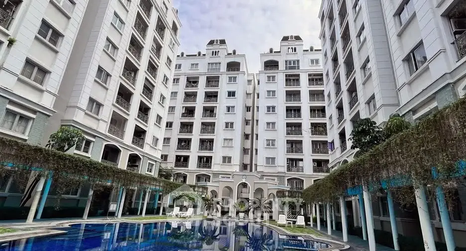 Luxurious residential building with stunning pool and lush greenery