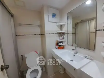 Pristine white bathroom with modern fixtures, ample lighting, and a large mirror, perfect for a refreshing start to the day.