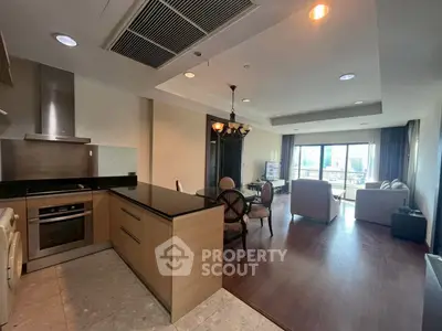 Spacious open-plan kitchen and living room with modern design and ample natural light.