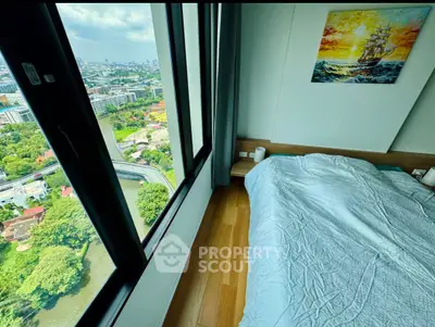 Stunning bedroom with panoramic city view from high-rise window, featuring cozy bedding and elegant decor.