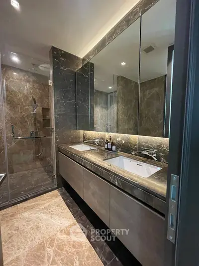 Luxurious modern bathroom with marble finishes and dual sinks