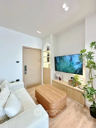 Modern living room with sleek furniture and wall-mounted TV, perfect for relaxation.