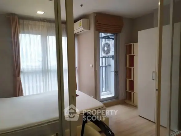 Modern bedroom with large window and air conditioning unit