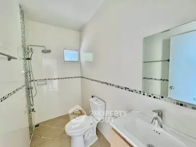 Modern bathroom with sleek fixtures and a spacious shower area, perfect for contemporary living.