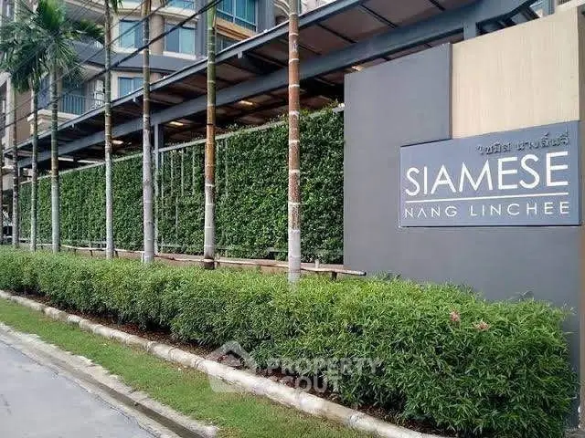 Modern building exterior with lush greenery at Siamese Nang Linchee