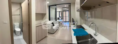 Modern apartment interior with open kitchen and cozy living area