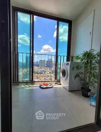 Stunning balcony view with washer and city skyline, perfect for urban living.