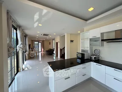 Spacious open-plan kitchen and living area with modern appliances and large windows.