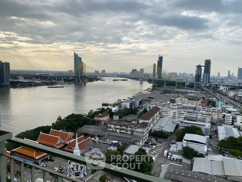 Stunning river view from high-rise balcony overlooking cityscape and iconic bridge.