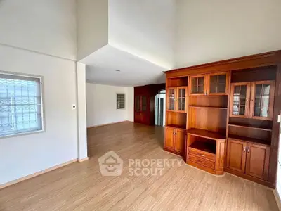 Spacious living room with elegant wooden cabinetry and natural light