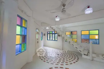 Charming interior with colorful stained glass windows and unique spiral floor design.
