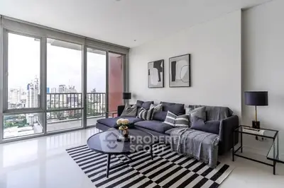 Modern living room with city view, stylish decor, and large windows.