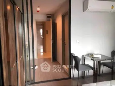 Modern apartment interior with sleek design and air conditioning, featuring a cozy dining area and stylish decor.
