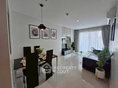 Modern living room with dining area, stylish decor, and large windows for natural light.