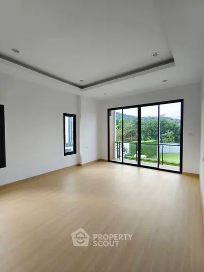 Spacious empty room with large windows and scenic view, ideal for customization.