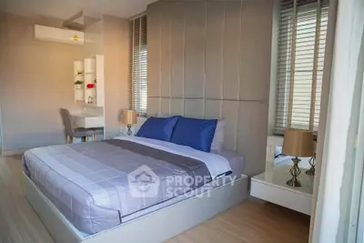 Modern bedroom with stylish decor and natural light