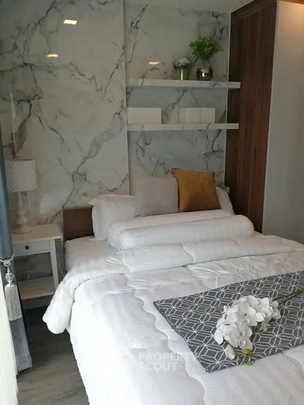 Luxurious bedroom with marble accent wall and elegant decor