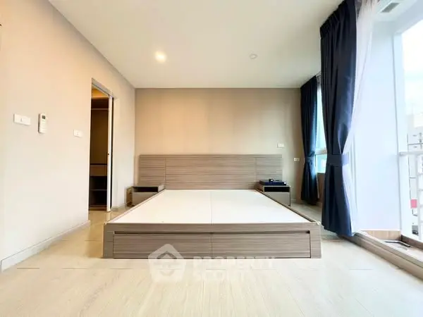 Spacious bedroom with modern design and large windows for natural light.