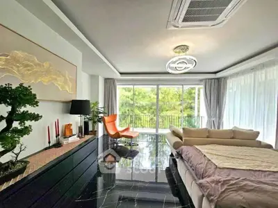 Luxurious living room with modern decor and large windows offering a stunning view of greenery.