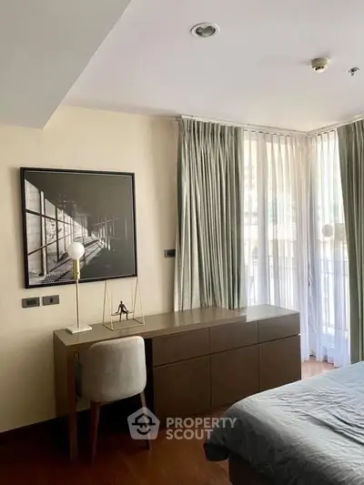 Modern bedroom with stylish desk and large window offering natural light