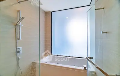 Luxurious bathroom with modern shower and bathtub, featuring frosted glass window for privacy.