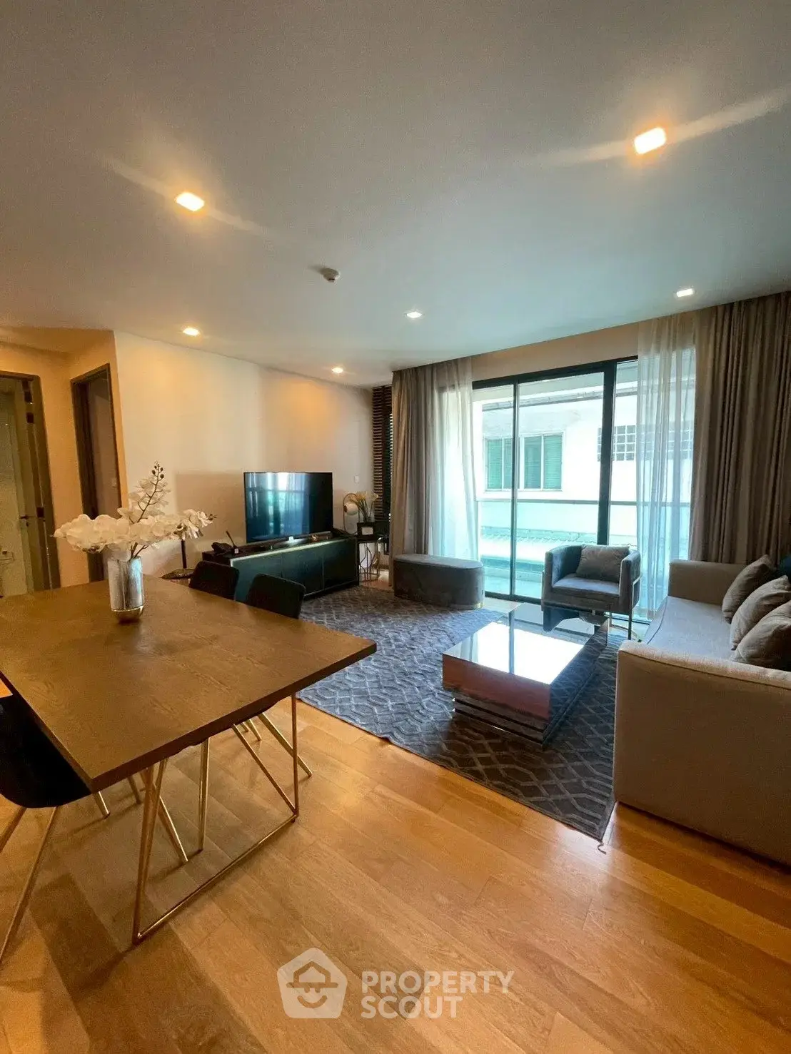 Spacious modern living room with elegant decor and large windows for natural light.