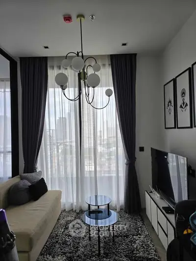 Modern living room with elegant decor and city view through large windows.