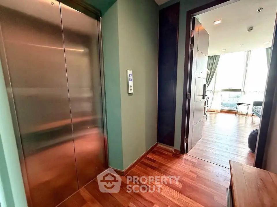 Modern apartment entrance with elevator and wooden flooring