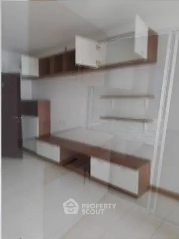 Blurry image of modern kitchen cabinets with open shelving
