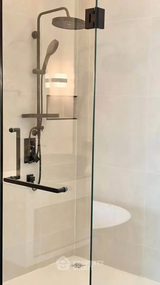 Modern bathroom shower with glass enclosure and sleek fixtures.