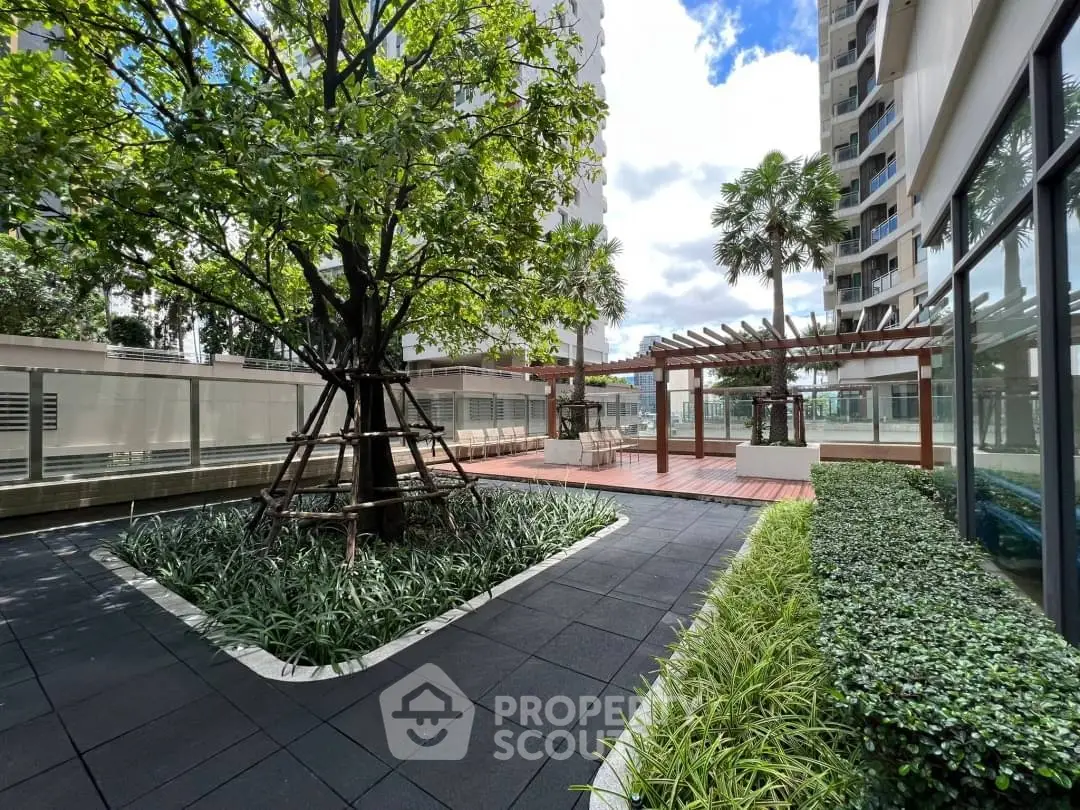 Modern apartment complex with lush garden and seating area