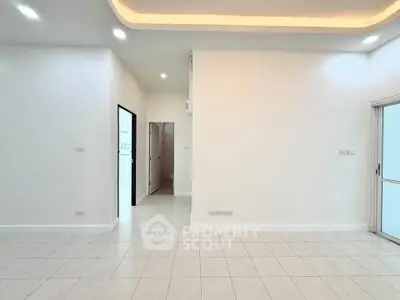 Spacious and bright interior with modern lighting and tiled flooring, perfect for customization.