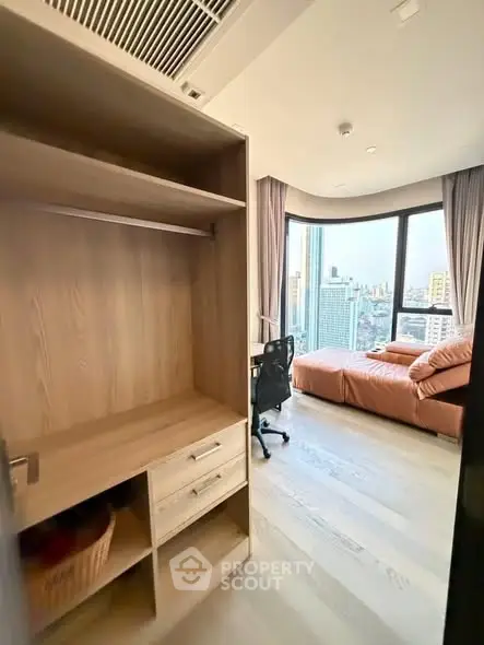 Modern apartment with city view, featuring a cozy living area and stylish furnishings.