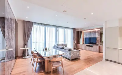 Spacious modern living room with elegant decor and large windows offering natural light.