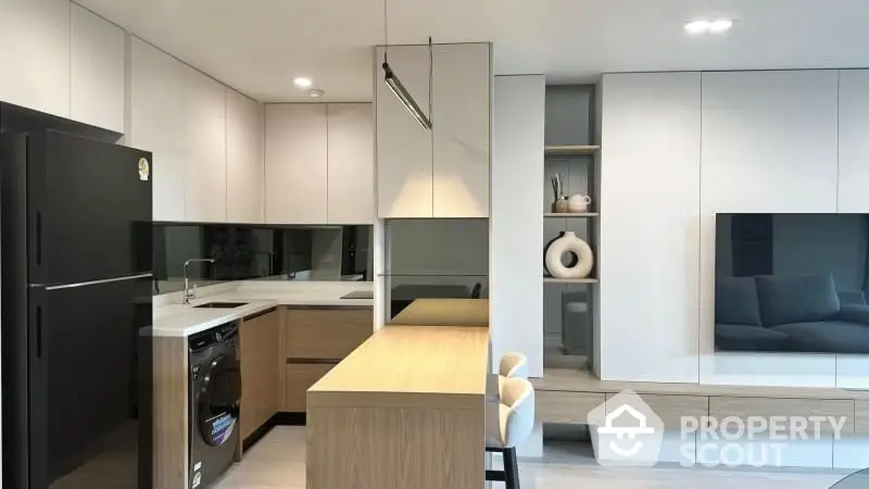 Modern kitchen with sleek design, featuring built-in appliances and stylish cabinetry.