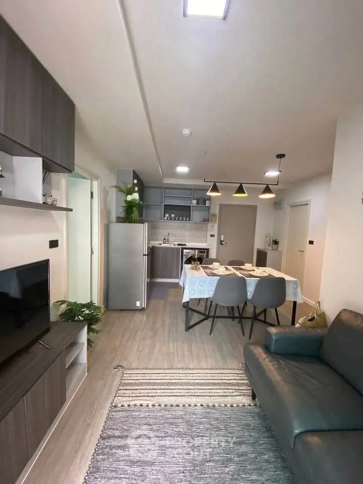Modern open-plan living room and kitchen with stylish decor and dining area.