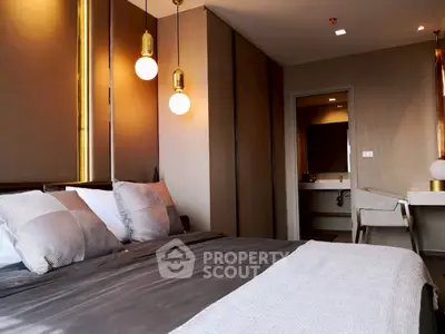 Modern bedroom with stylish lighting and ensuite bathroom in luxury apartment