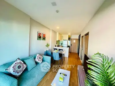 Modern living room with open kitchen, stylish decor, and natural light