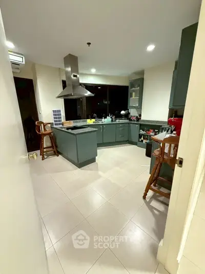 Spacious kitchen with modern cabinetry and central island in a stylish home.