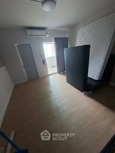 Spacious unfurnished bedroom with air conditioning and natural light.