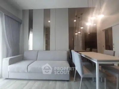 Modern living room with elegant dining area and stylish lighting fixtures.