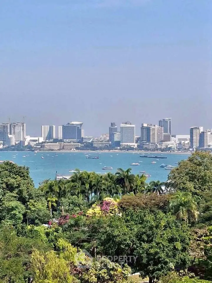 Stunning city skyline view with lush greenery and waterfront, perfect for urban living.