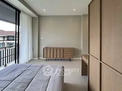 Spacious modern bedroom with large windows and minimalist furniture