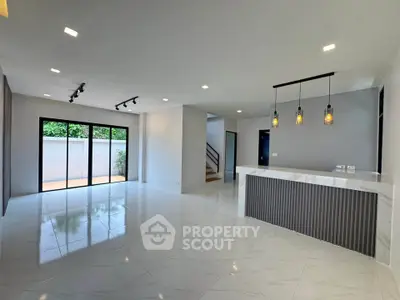 Spacious modern living room with open layout and stylish lighting