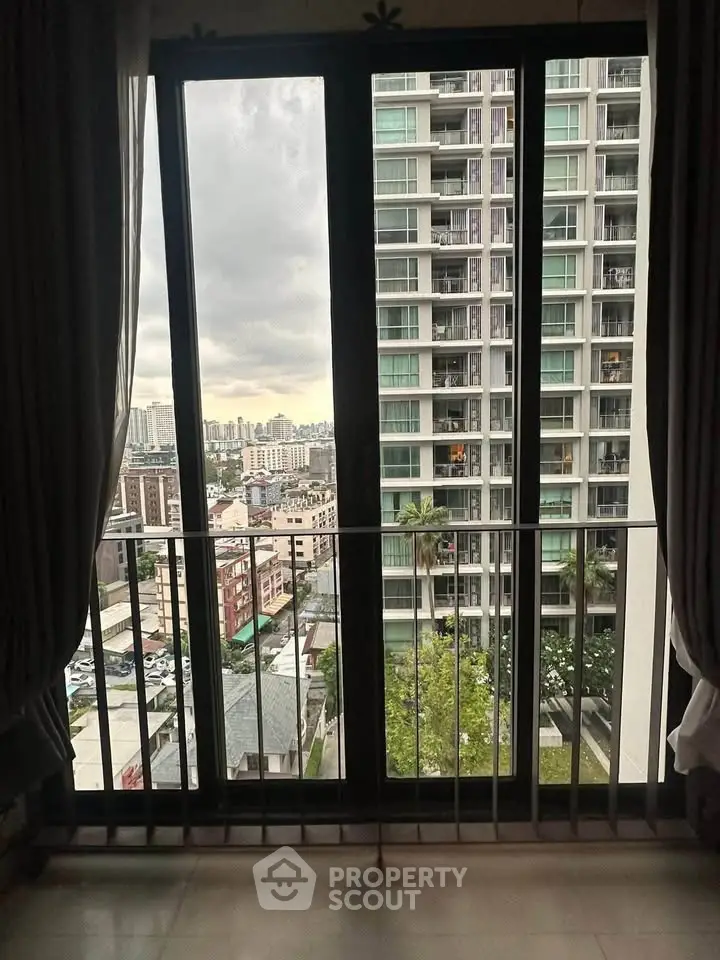 Stunning cityscape view from a high-rise apartment window, showcasing urban living at its finest.