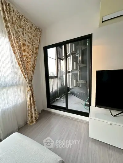 Modern living room with balcony view and elegant curtains